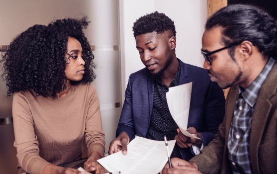 Three people reviewing a document