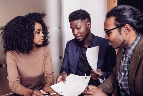 Three people reviewing a document